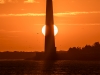 Ol'Barney at Sunrise. The sun rises directly behind  the lighthouse.